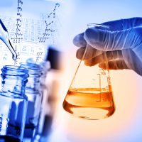 Flask in scientist hand with laboratory background Flask in scientist hand with laboratory background, science research and development concept.