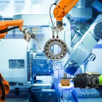Industrial robotic welding and robot gripping working on smart factory, industry 4.0 and technology concept Industrial robotic welding and robot gripping working on smart factory, on machine blue tone color background, industry 4.0 and technology.